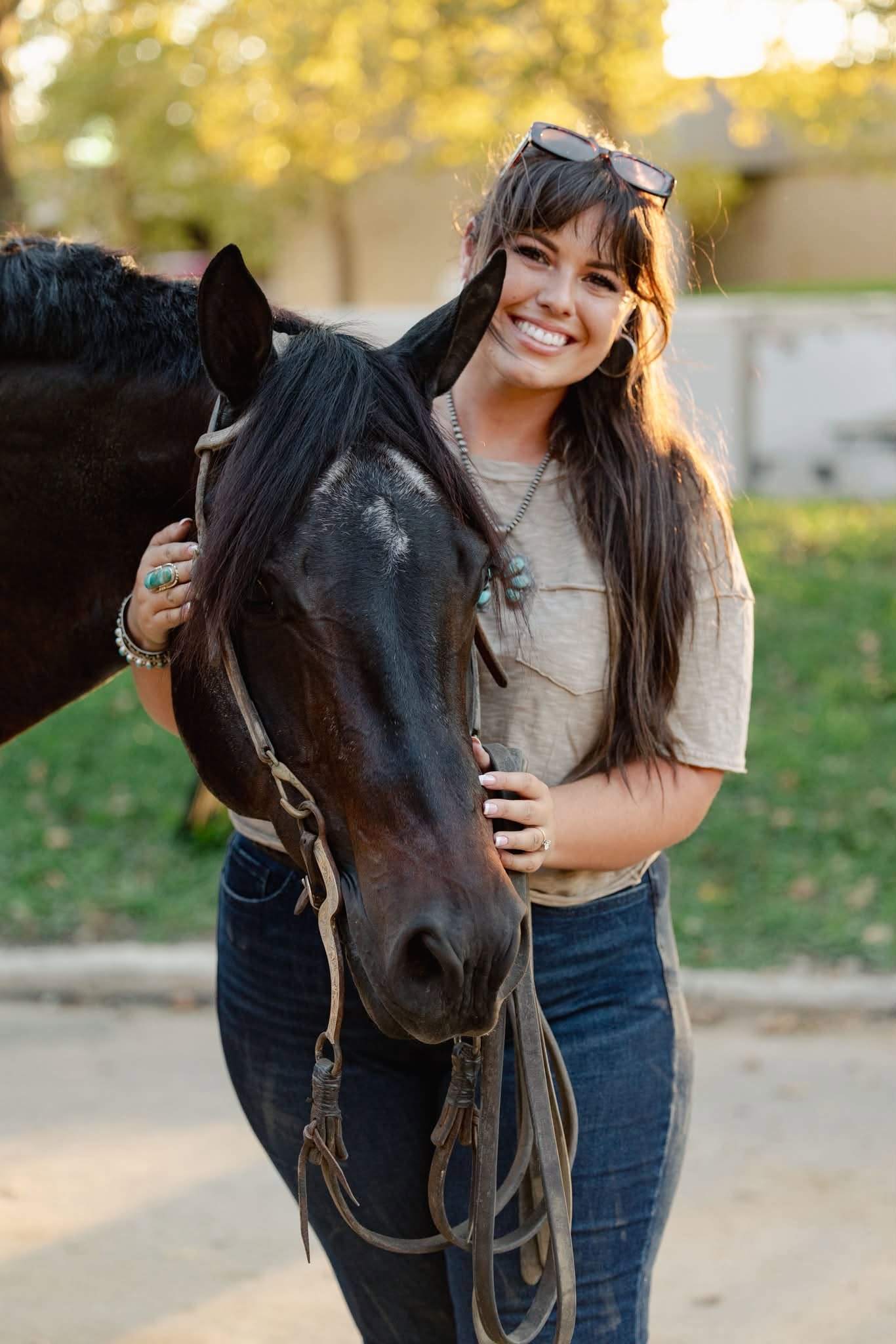 Woman standing beside a dark horse